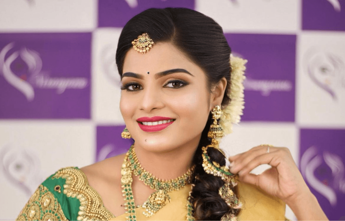 Bride receiving professional bridal makeup application in T. Nagar studio