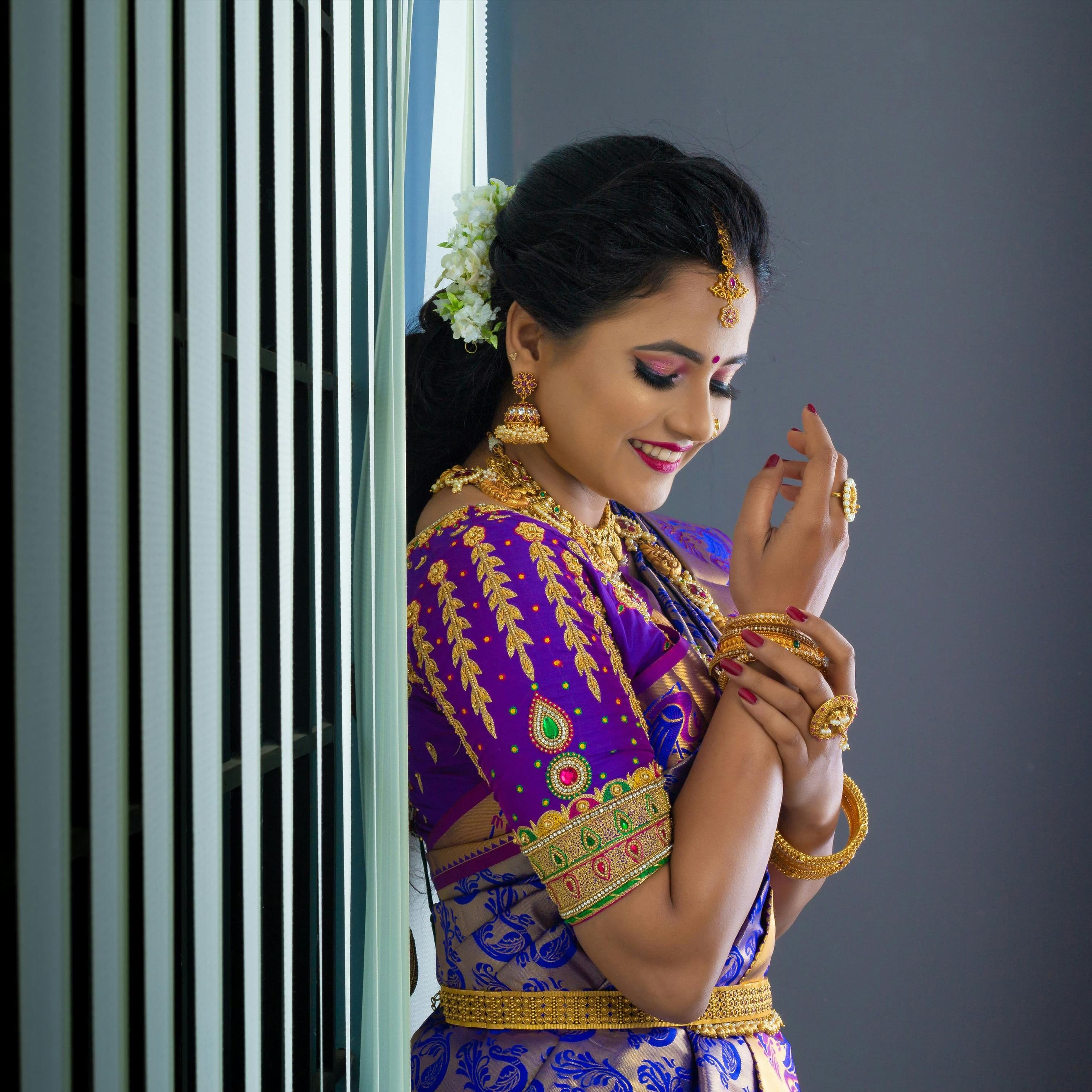 Bridal makeup in Pallavaram, Chennai featuring dewy skin, soft nude lips, and traditional South Indian hairstyle